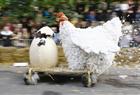 A barnyard-inspired competitor rides his homemade vehicle down a Warsaw street during the Red Bull Soapbox Race on Sept. 23.